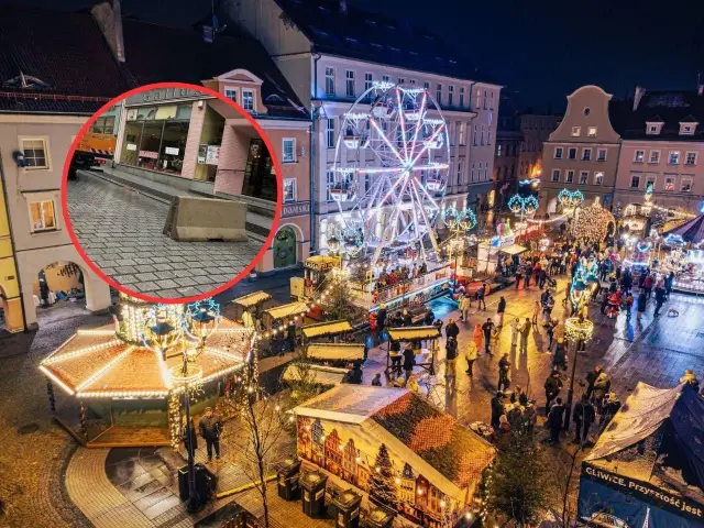 Gliwice jarmark bożonarodzeniowy nocą. Wesołe miasteczko, stragany, tłumy ludzi i betonowa bariera bezpieczeństwa.